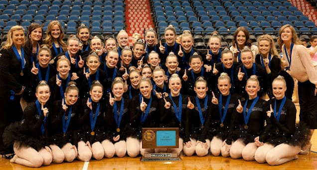 2011-2012 Lightning Dance Team celebrating with medals and cheering.