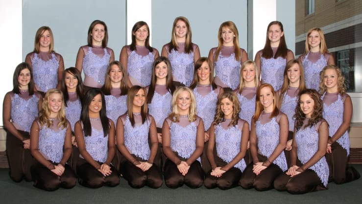 Group photo of the Lightning Dance Team in purple and brown costumes.