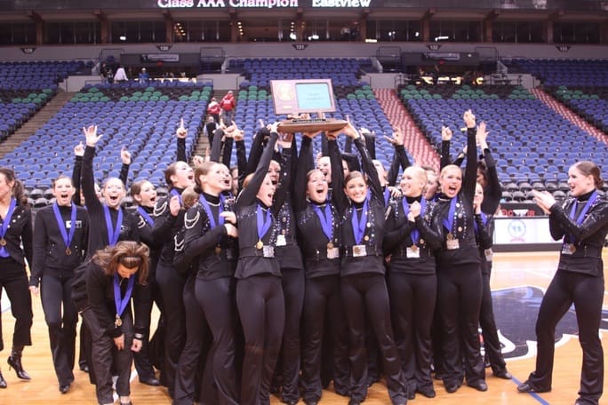 The Lightning Dance Team celebrating their victory, holding a championship trophy.